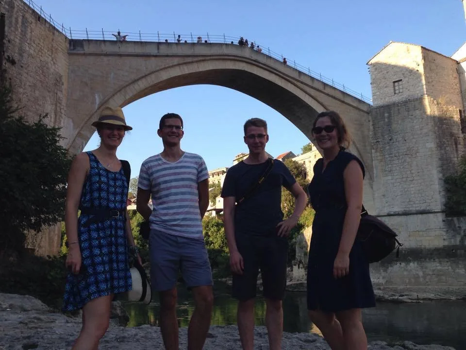 Tour group listening to guide explain Mostar's history