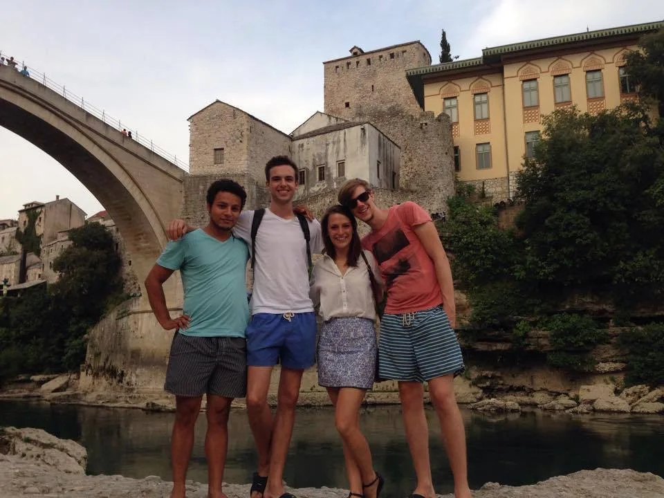 Walking tour group learning about Mostar's war history