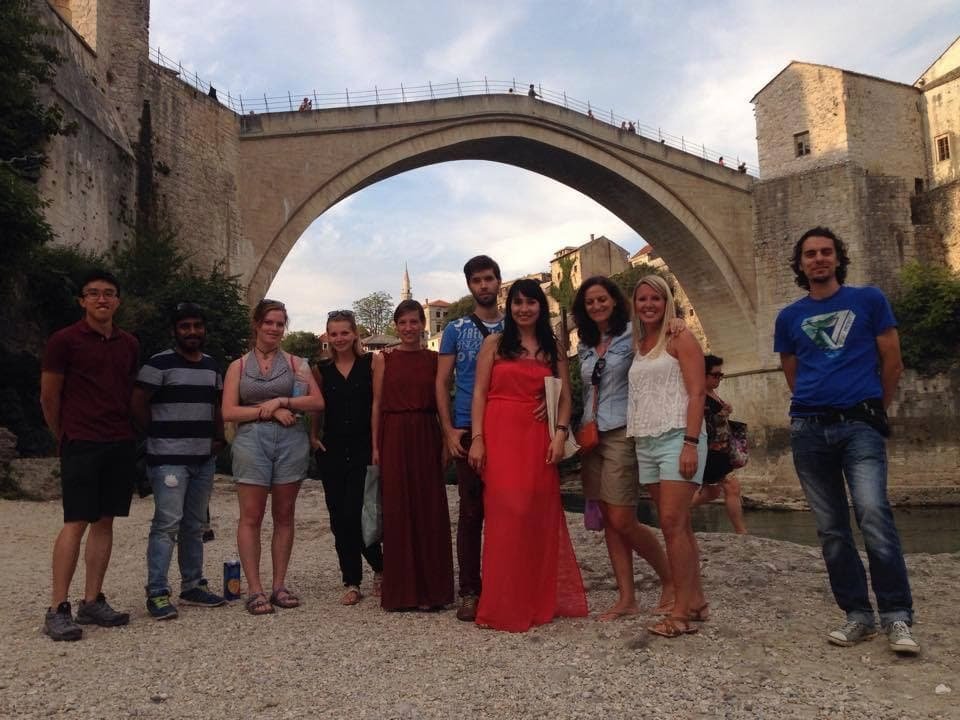 Tourists exploring Mostar's Ottoman architecture with local guide