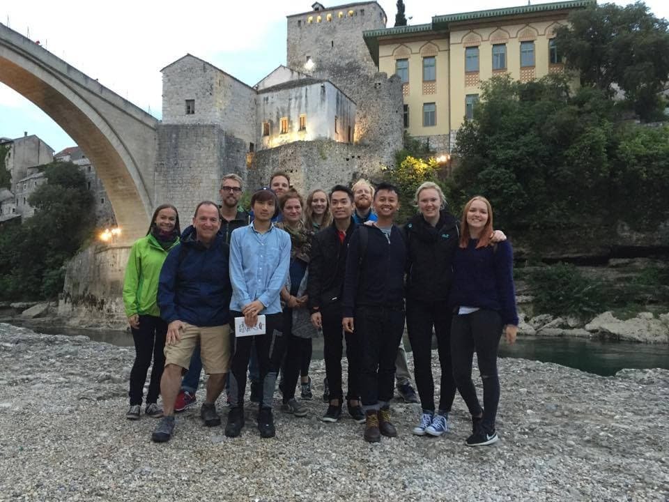 Local guide with tour group in Mostar's historic old town
